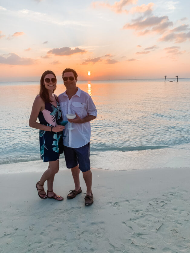 Maldives packing list: Lindsey and Jon cocktails on the beach during sunset at Anantara Veli Maldives