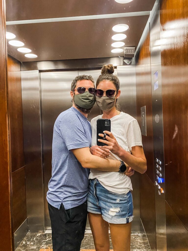Lindsey and Jon with masks in hotel elevator
